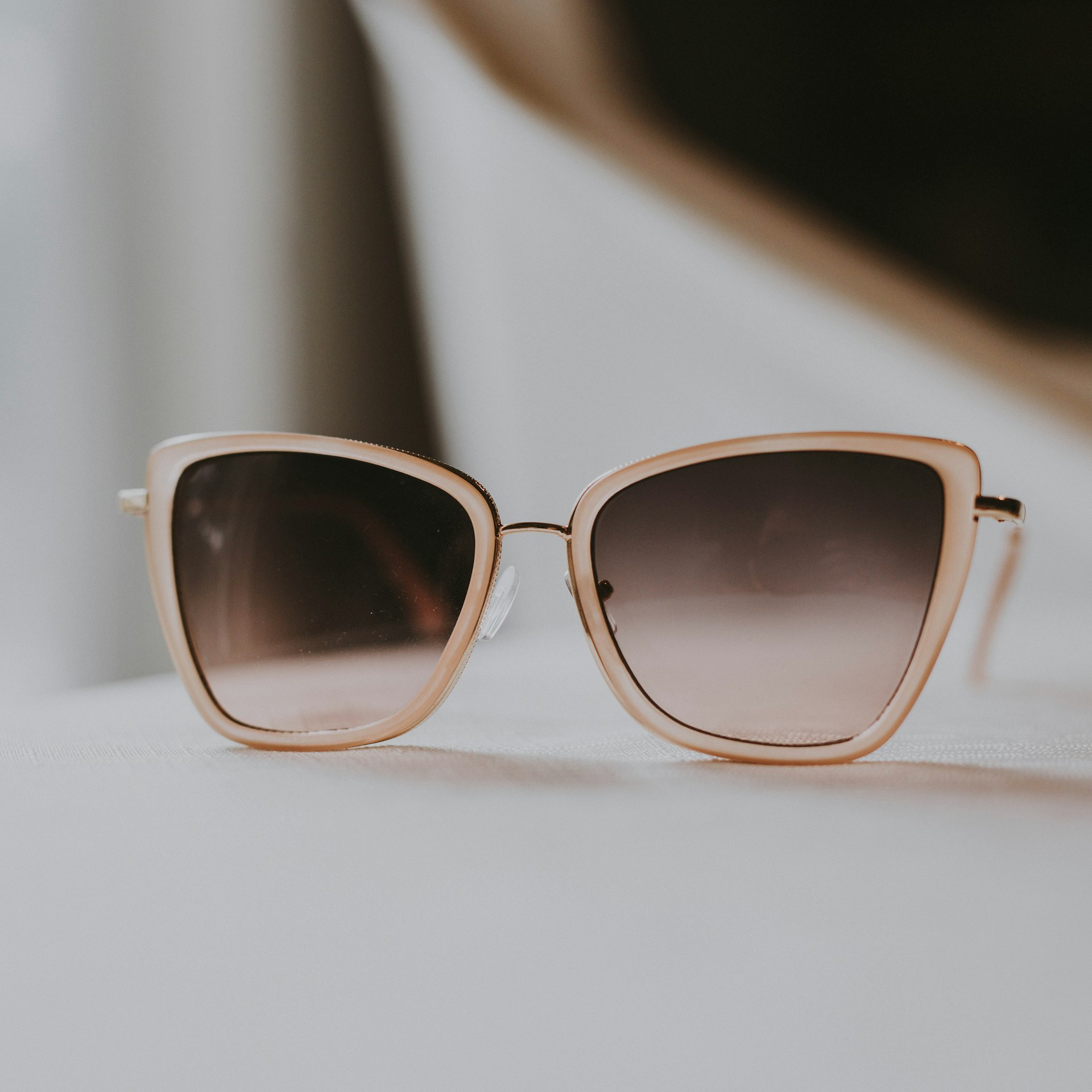 Soft cat-eye frames with Fuse gradient lenses on neutral fabric