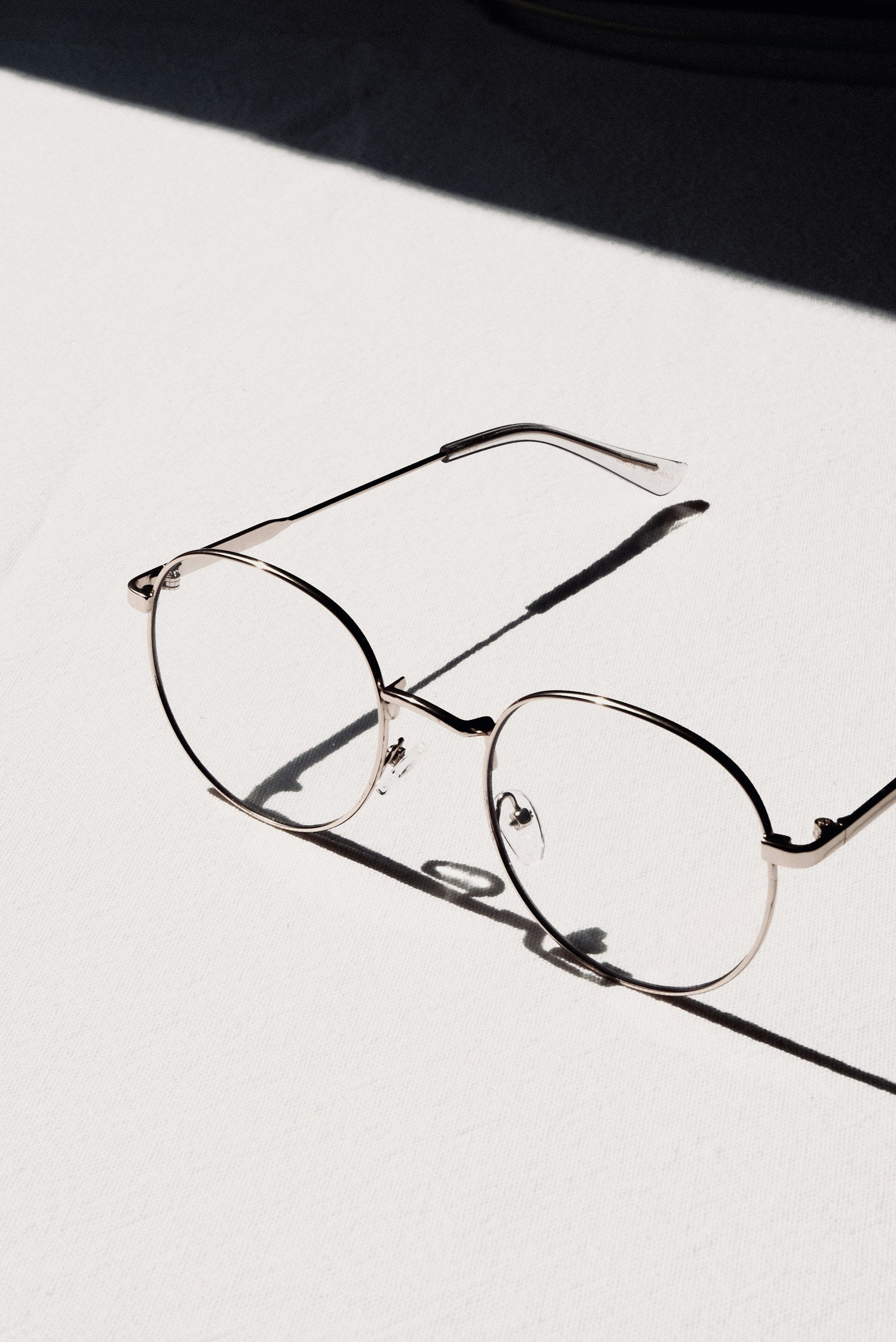 Gold round frames with fresh Fuse lenses, lit by hard sunlight